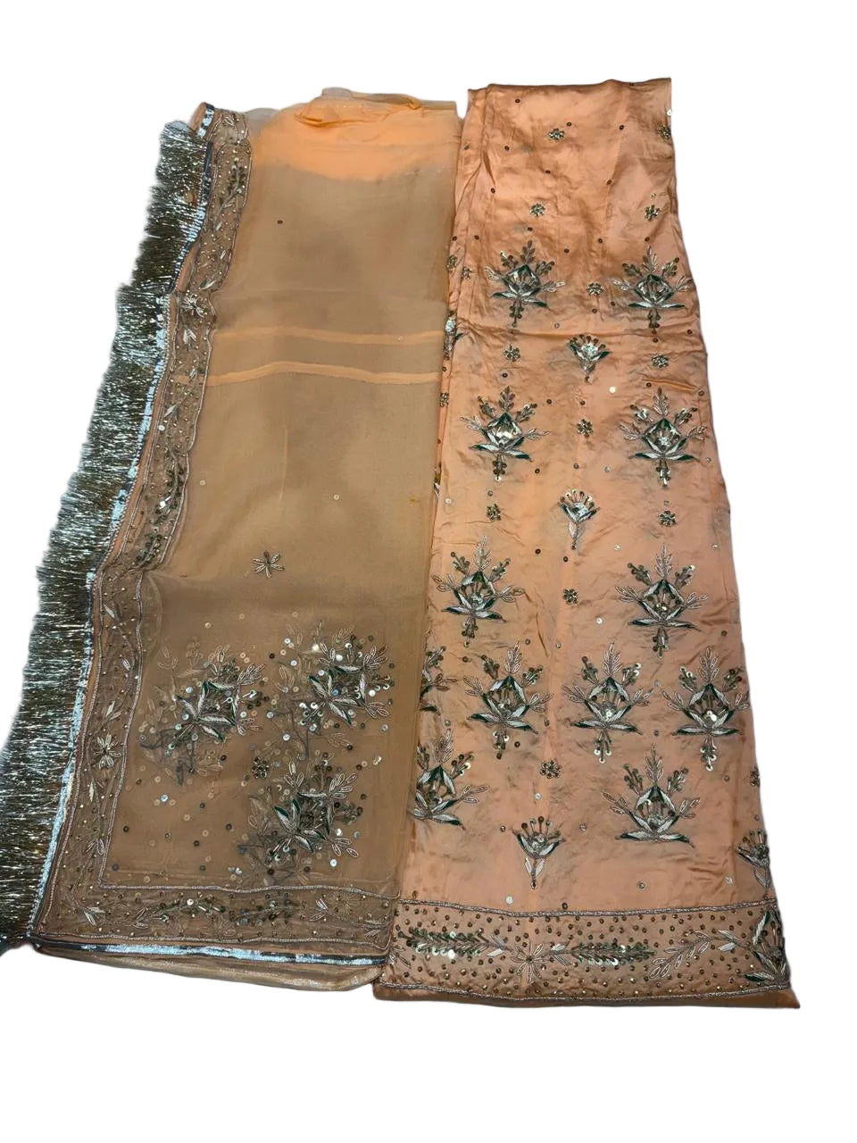 Decorative fabric with floral patterns and embellishments on a plain background