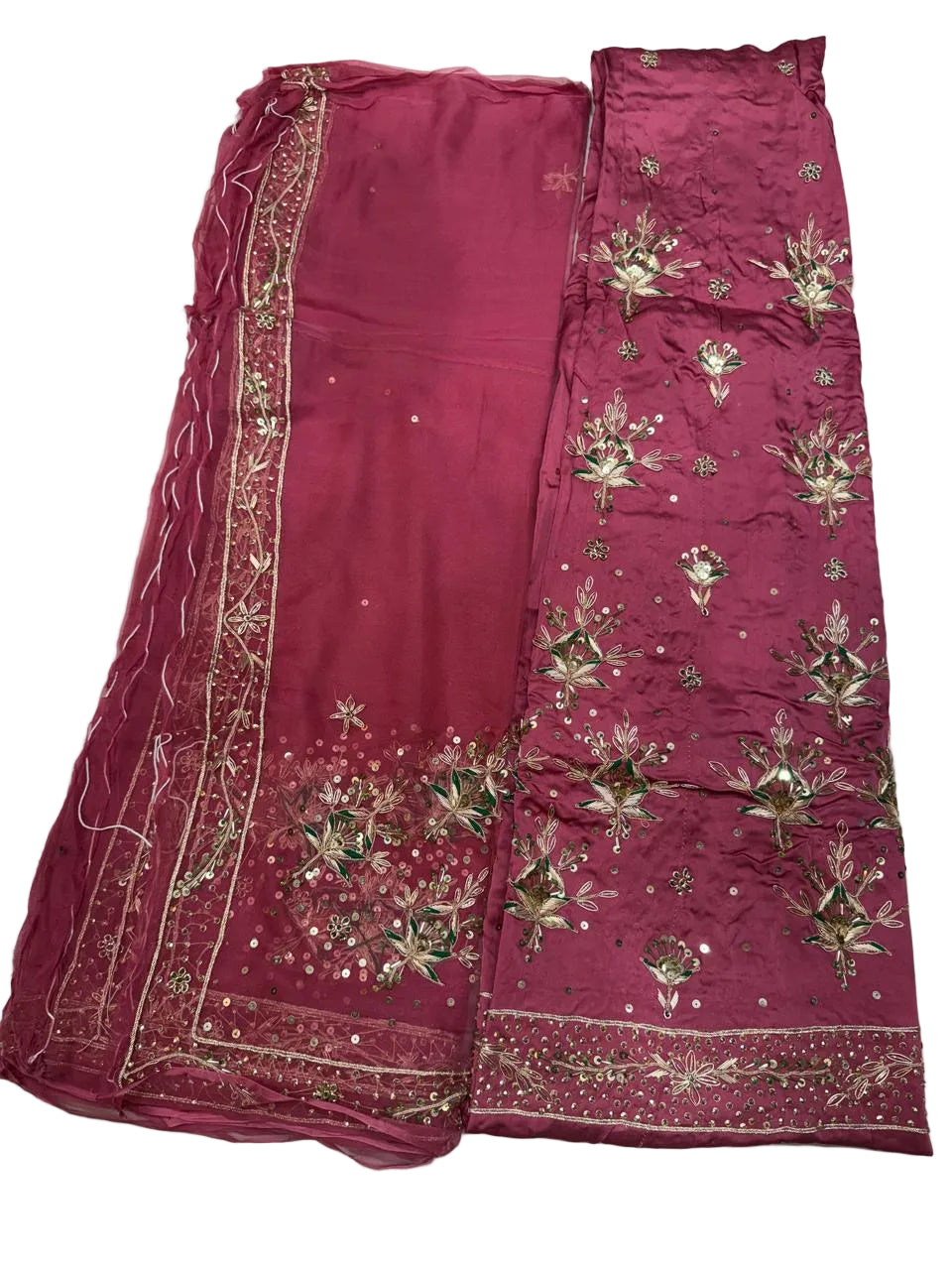 Maroon saree with gold embroidery on a white surface