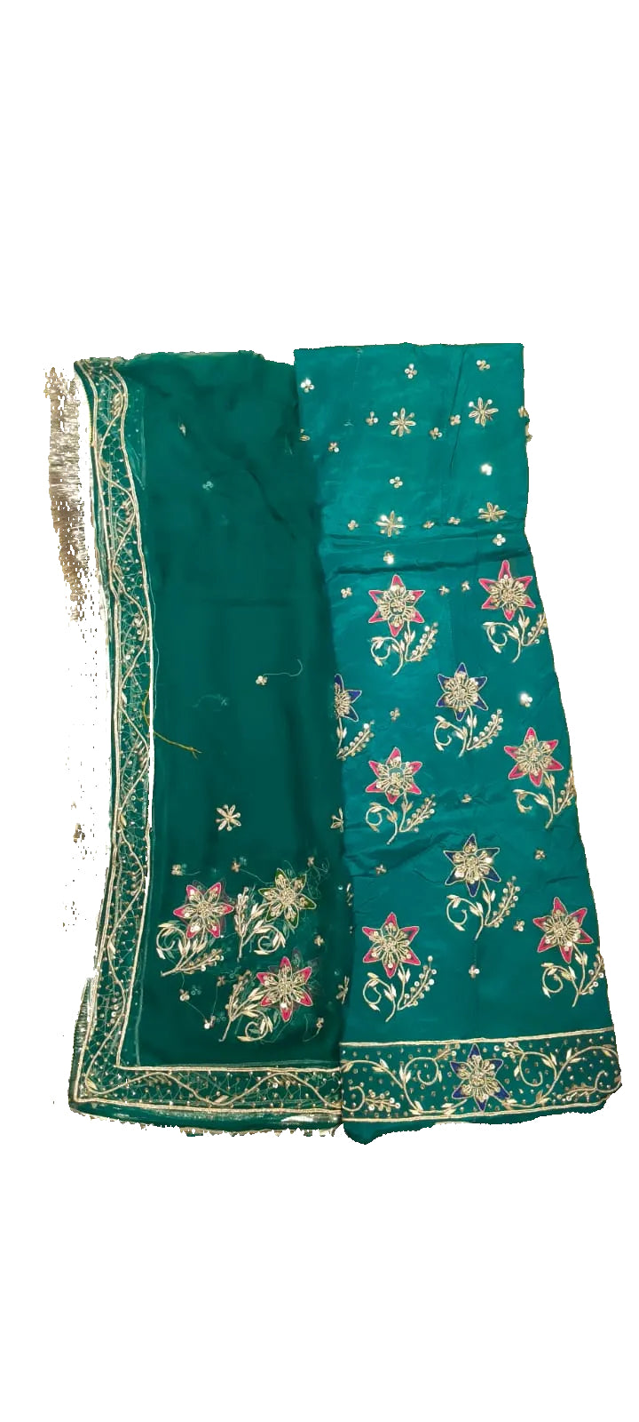Green embroidered fabric on a beige surface with feet visible at the bottom.