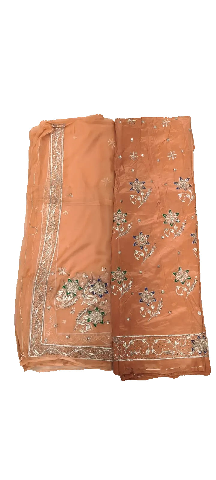 Orange fabric with floral embroidery on a white bedspread