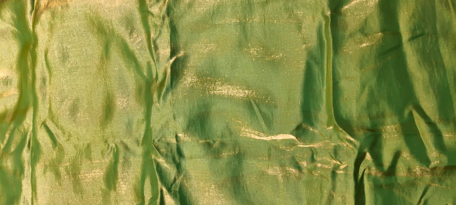 Textured green fabric with a subtle pattern