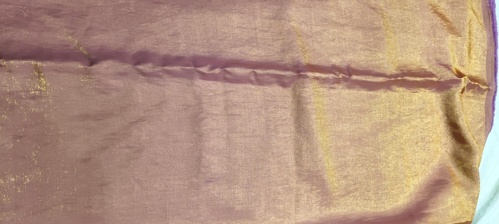 Close-up of a fabric with a purple and gold pattern