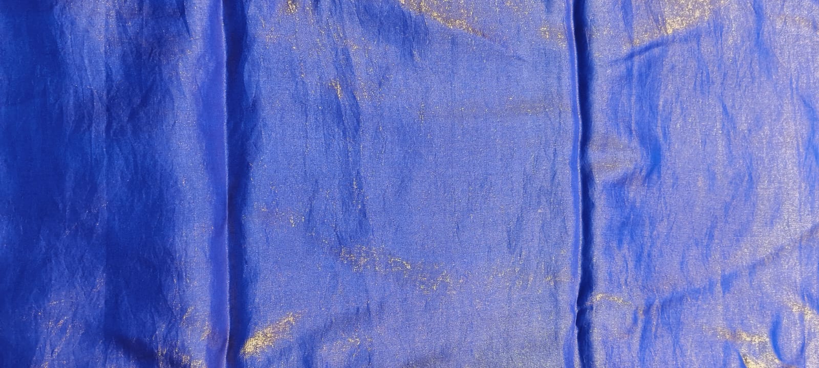 Close-up of blue fabric with gold accents