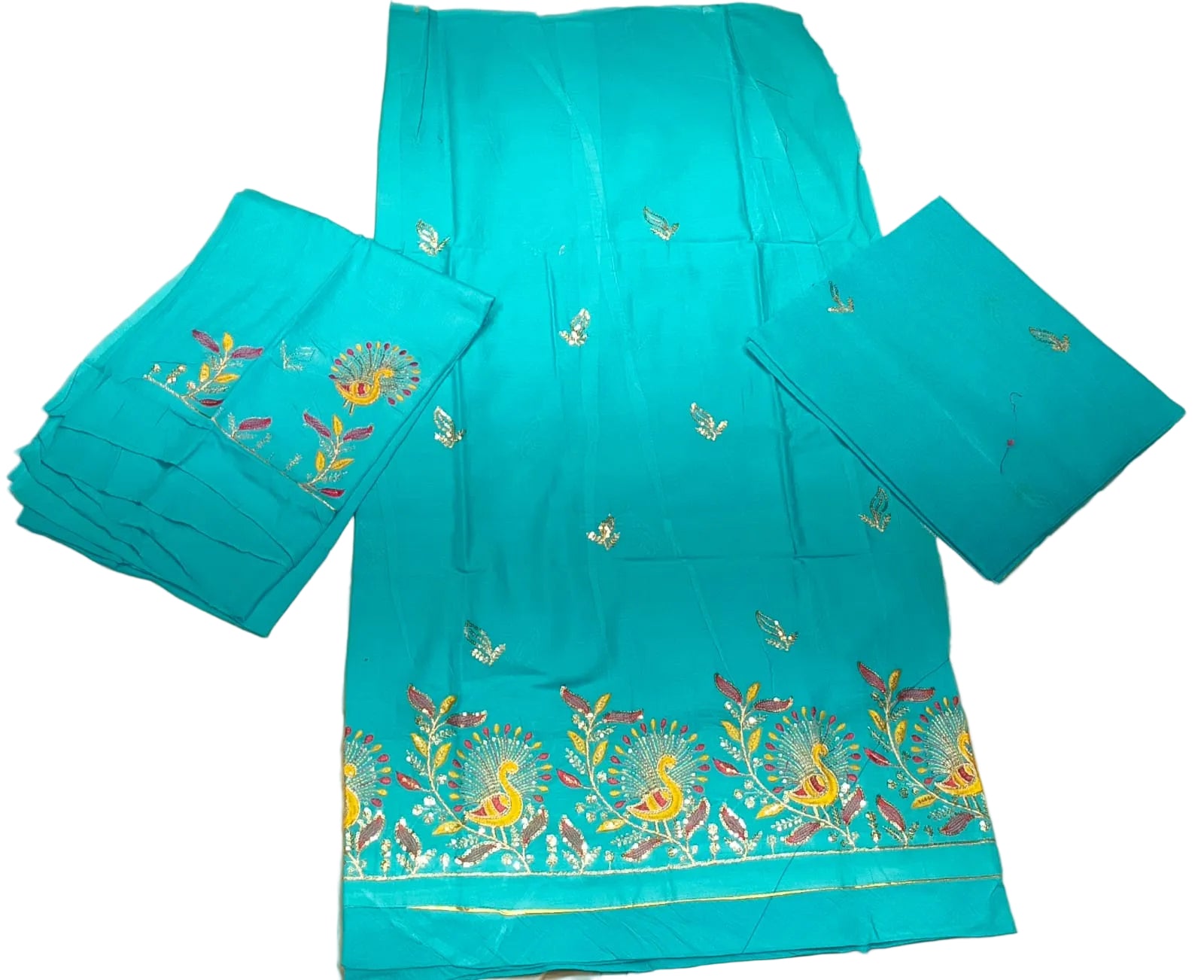 Turquoise fabric with intricate embroidery on a beige surface