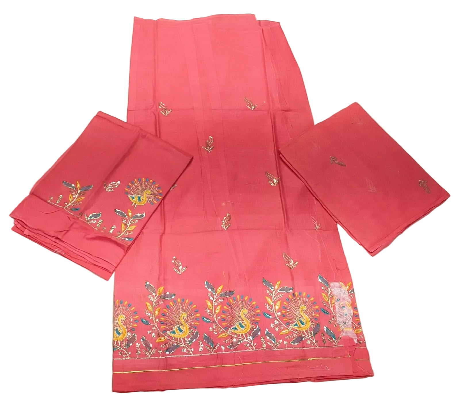 Red fabric with floral embroidery on a white surface