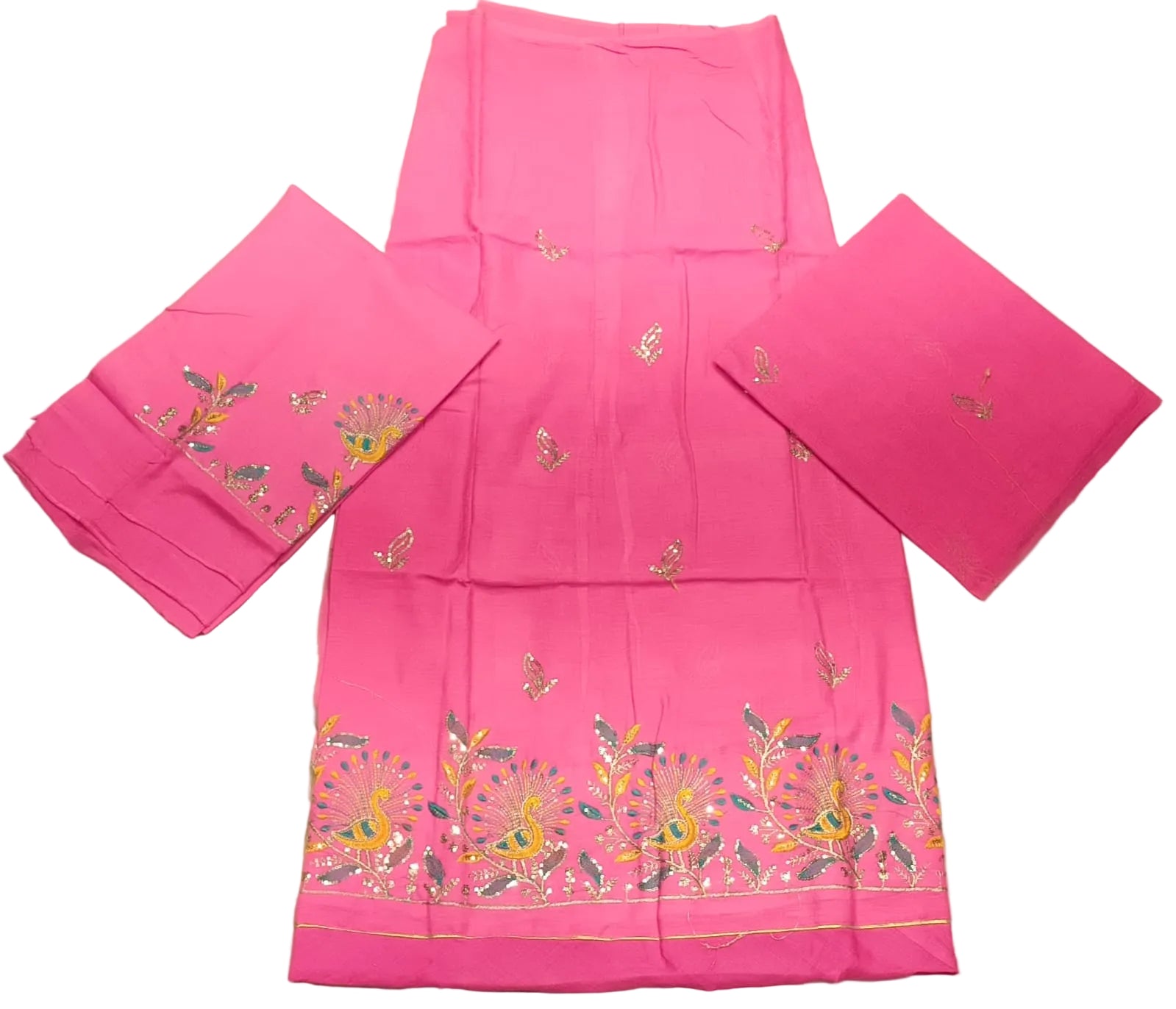 Pink embroidered fabric on a beige surface