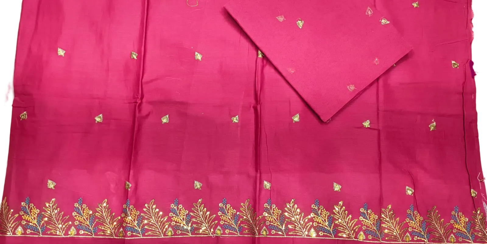 Pink saree with floral patterns on a plain background