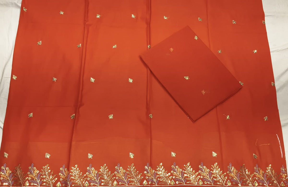 Red fabric with gold embroidery on a white background