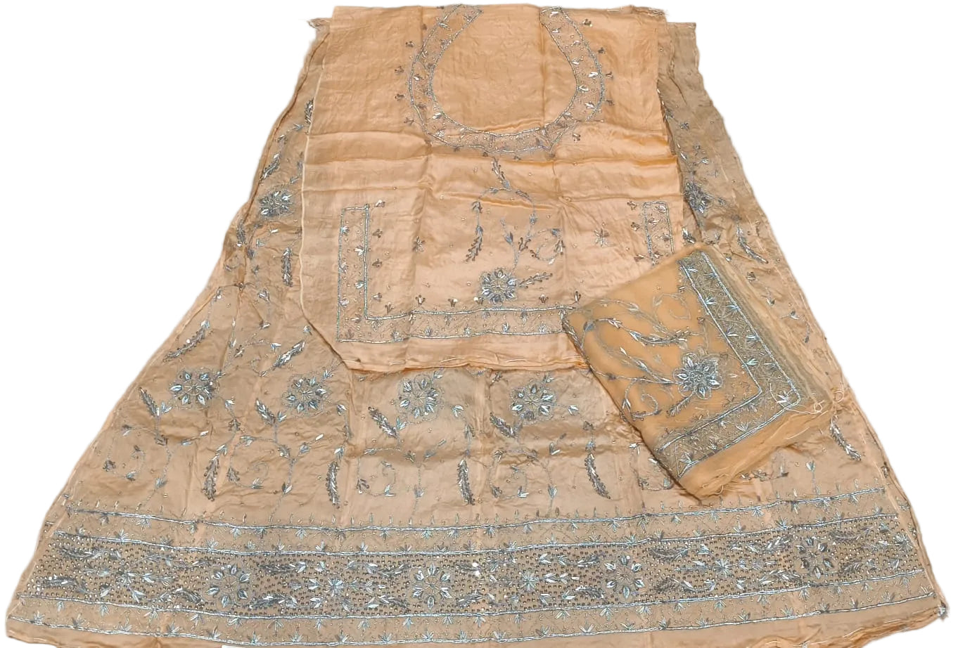 Beige fabric with silver embroidery on a light gray background