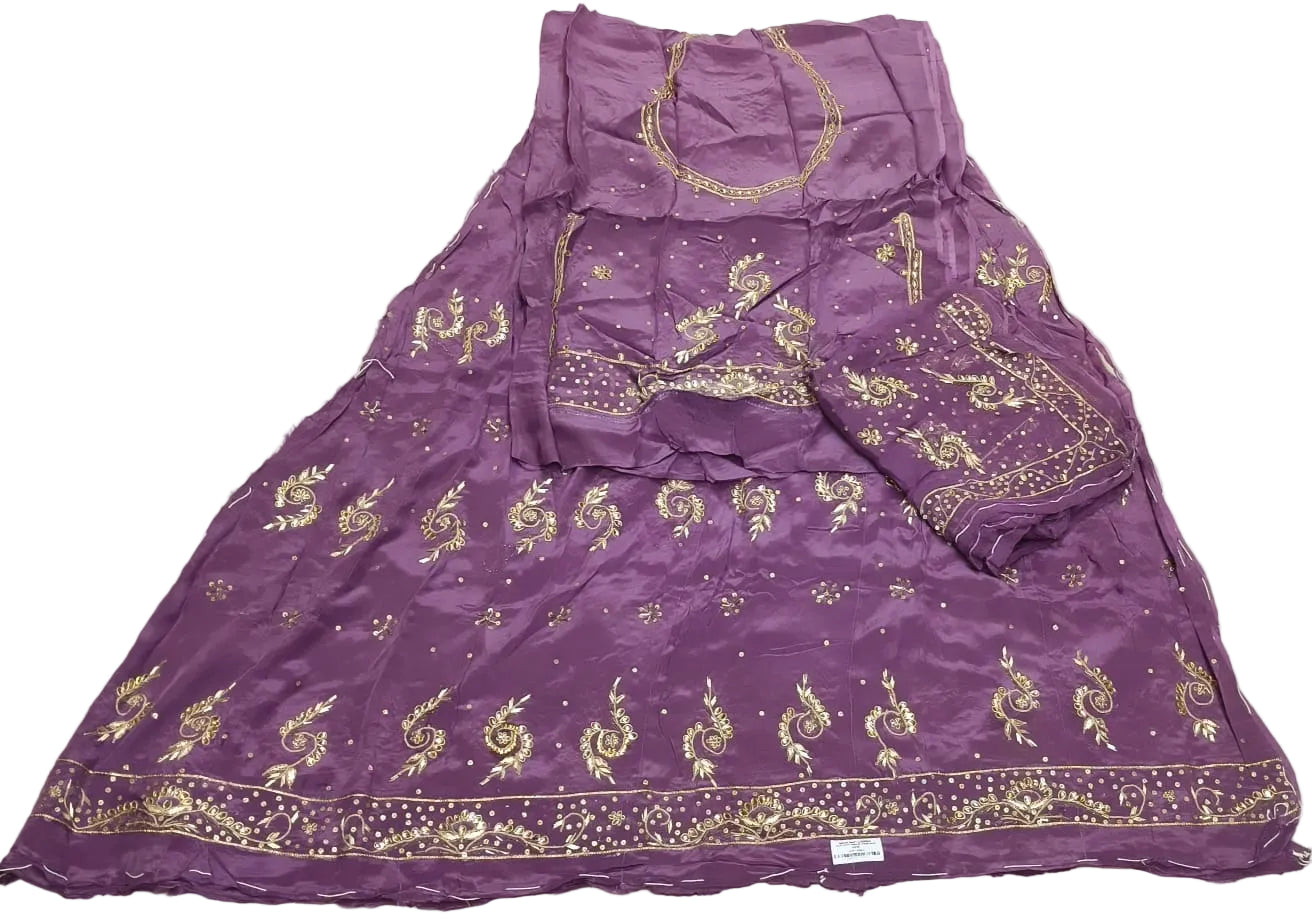 Purple traditional outfit with gold embroidery on a white fabric background