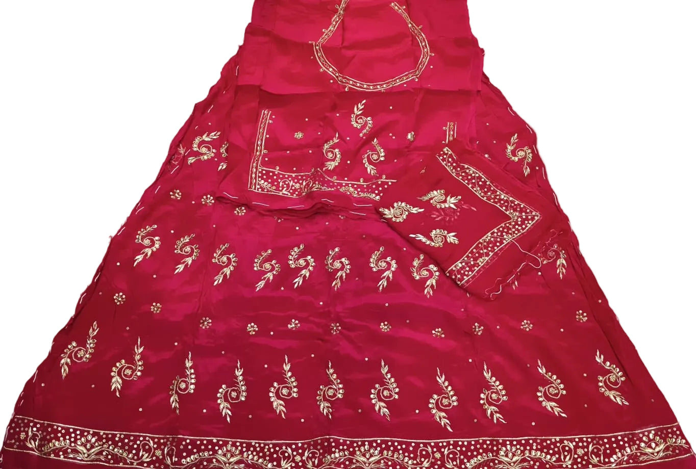 Red embroidered traditional outfit on a white surface