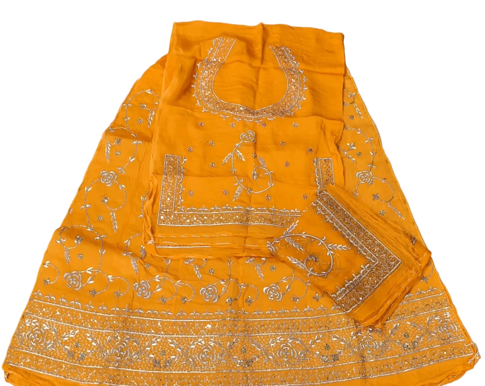 Yellow traditional outfit with intricate silver embroidery on a white fabric background