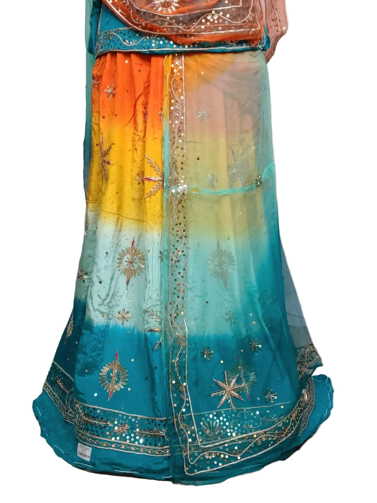 A traditional Indian lehenga choli skirt set with a vibrant orange, yellow, and teal gradient, decorated with gold zari embroidery and mirror work.