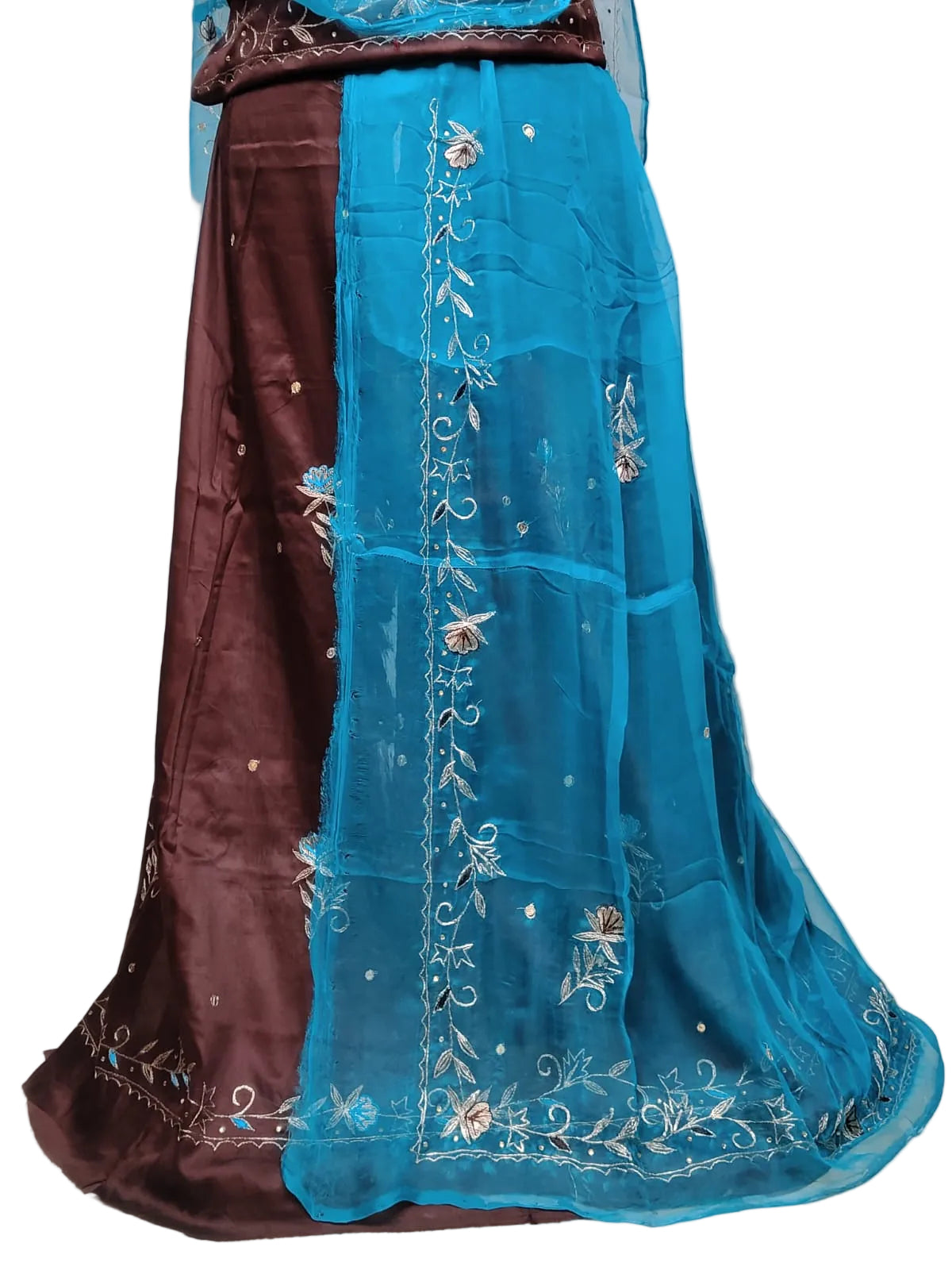A traditional Indian skirt set featuring a dark brown skirt with subtle gold embroidery and a sheer turquoise blue dupatta draped over it, decorated with floral and vine embroidery.