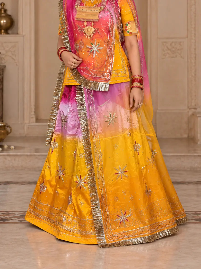 Yellow natural crepe lehenga fading to pink and lavender at the waist, with zardozi handwork stars, a worked hem band and a golden frilled odhni edge