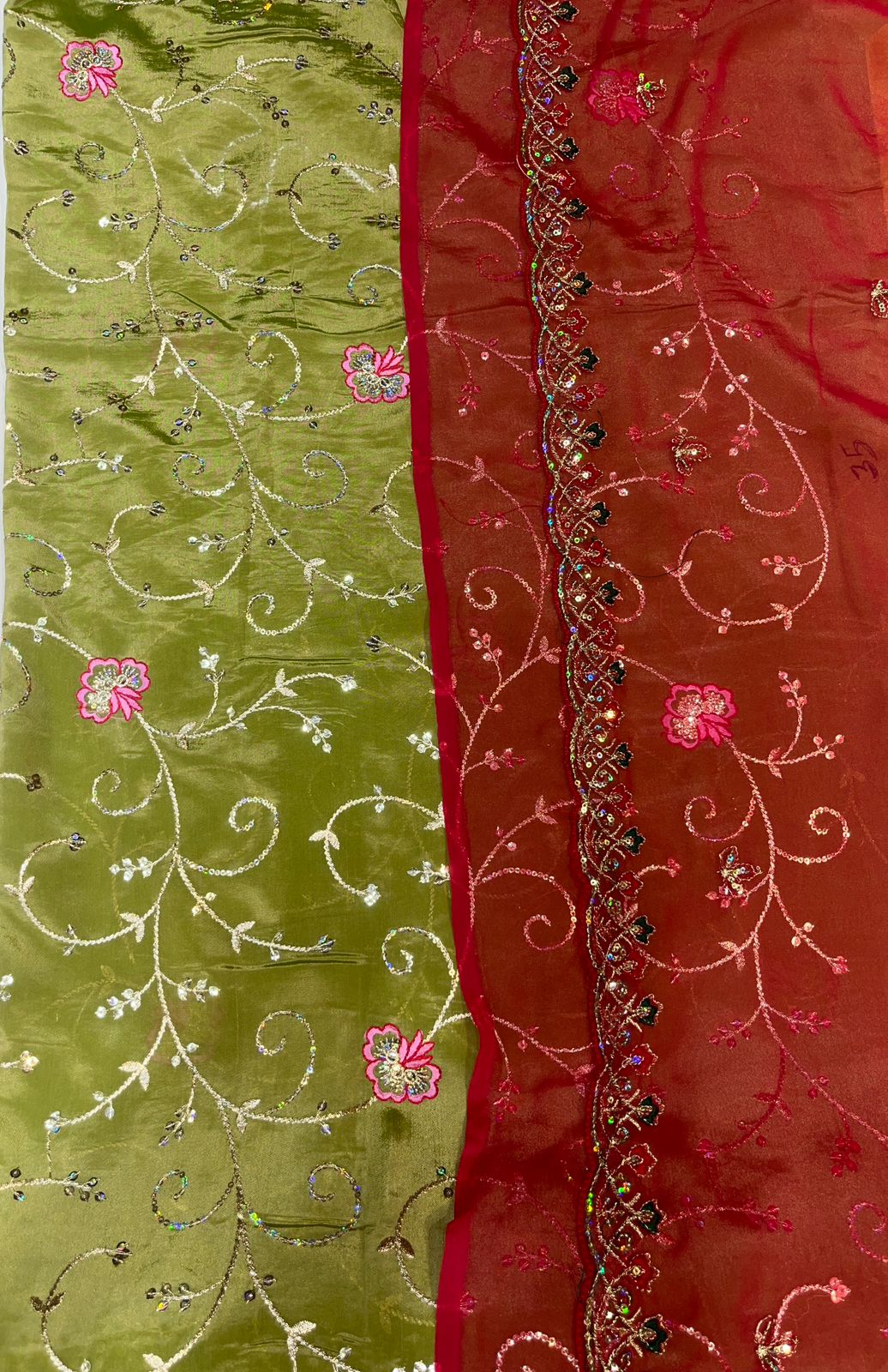Green and red fabric with floral embroidery