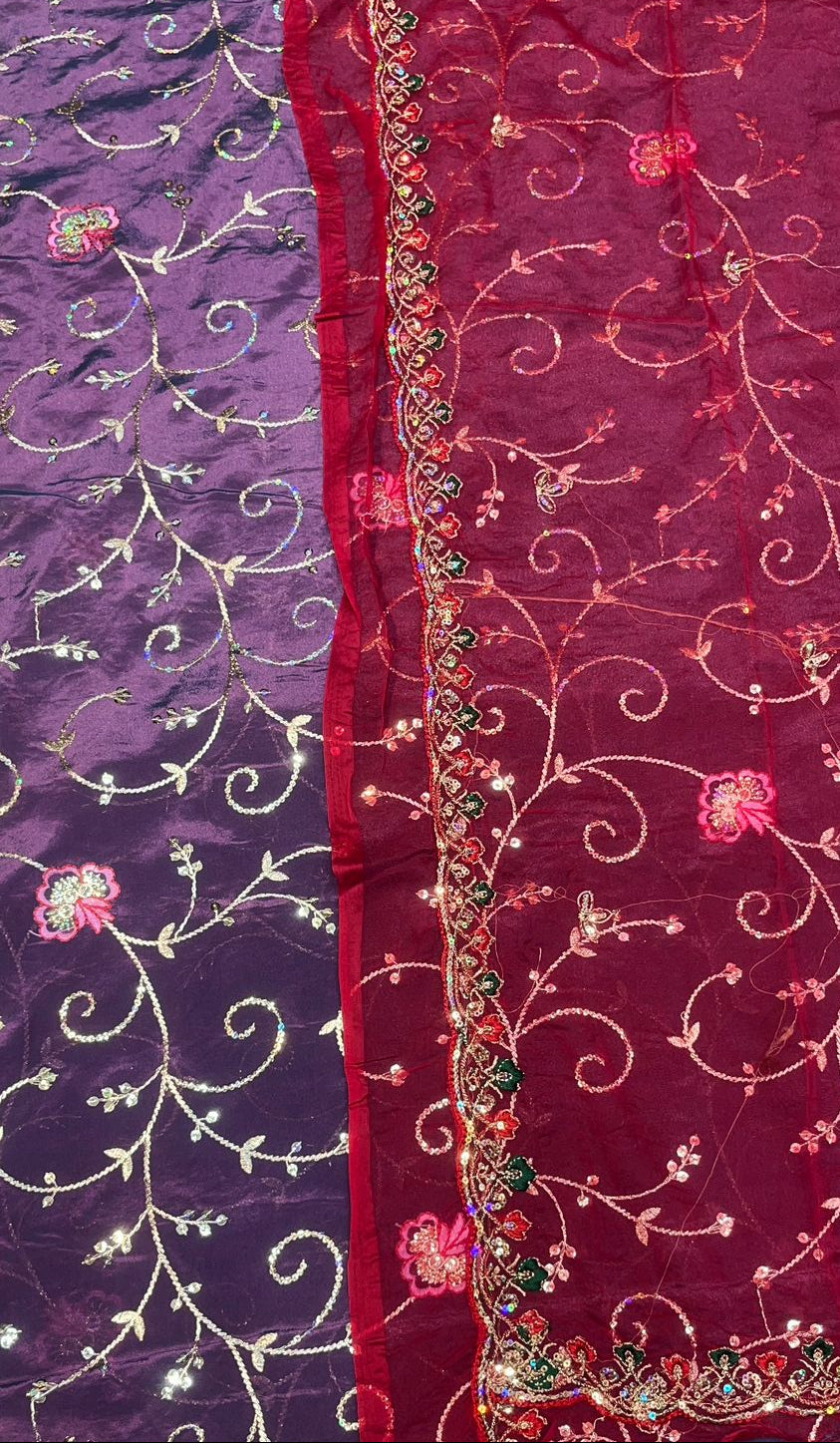 Two fabric samples with intricate patterns, one purple and one red with floral designs.