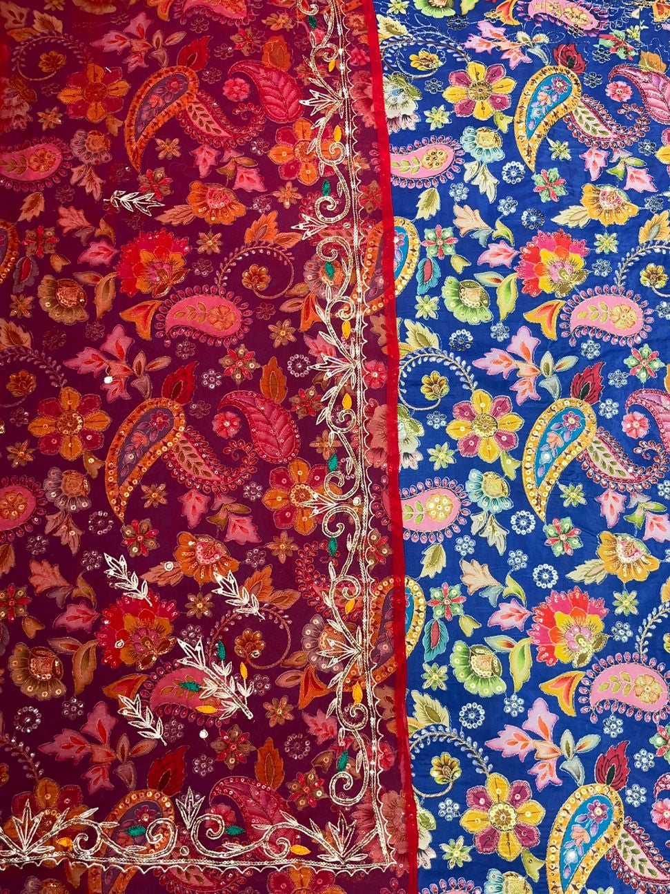 Two pieces of fabric with colorful paisley patterns, one red and one blue.