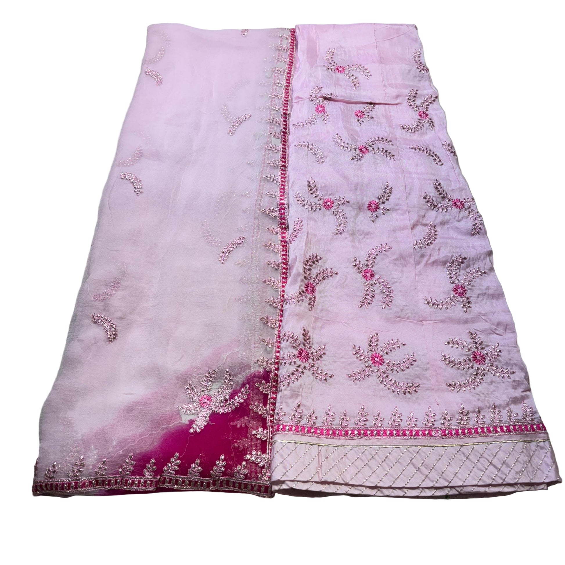 Pink embroidered fabric on a light gray background