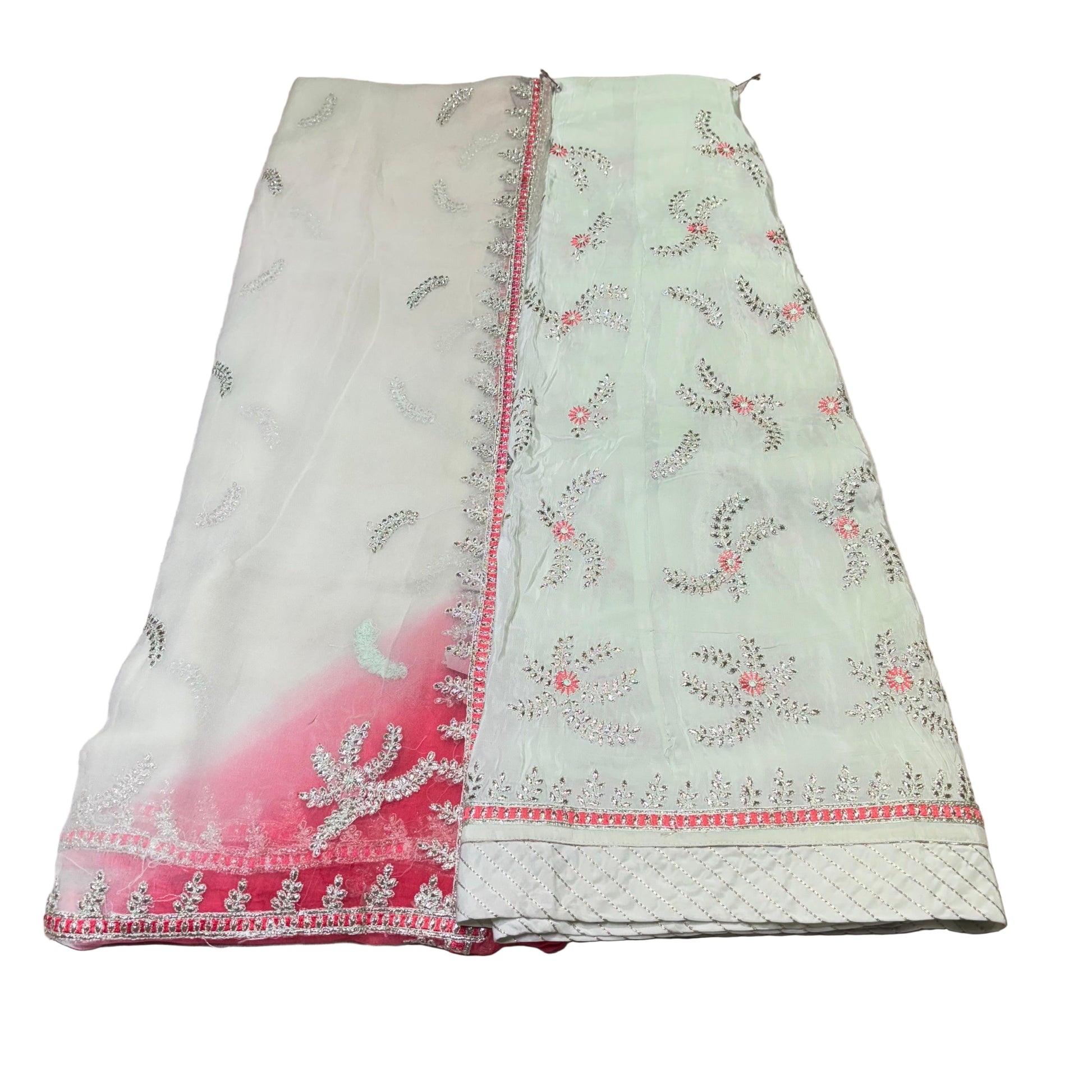 Light green fabric with floral embroidery on a textured surface
