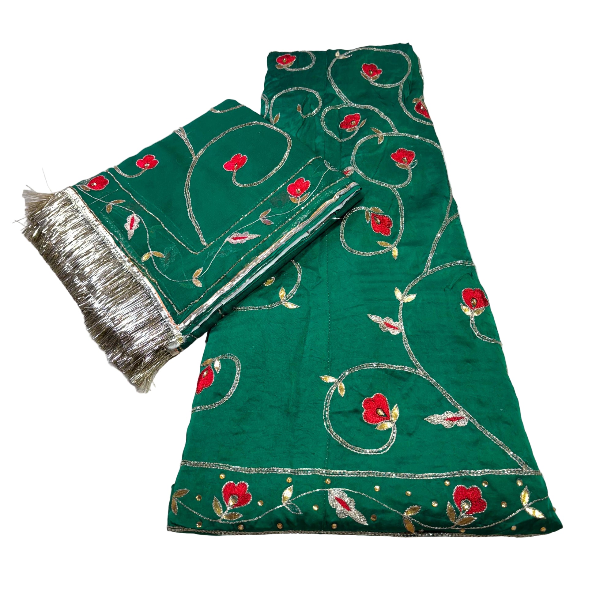 Green embroidered fabric with red floral patterns on a light gray background