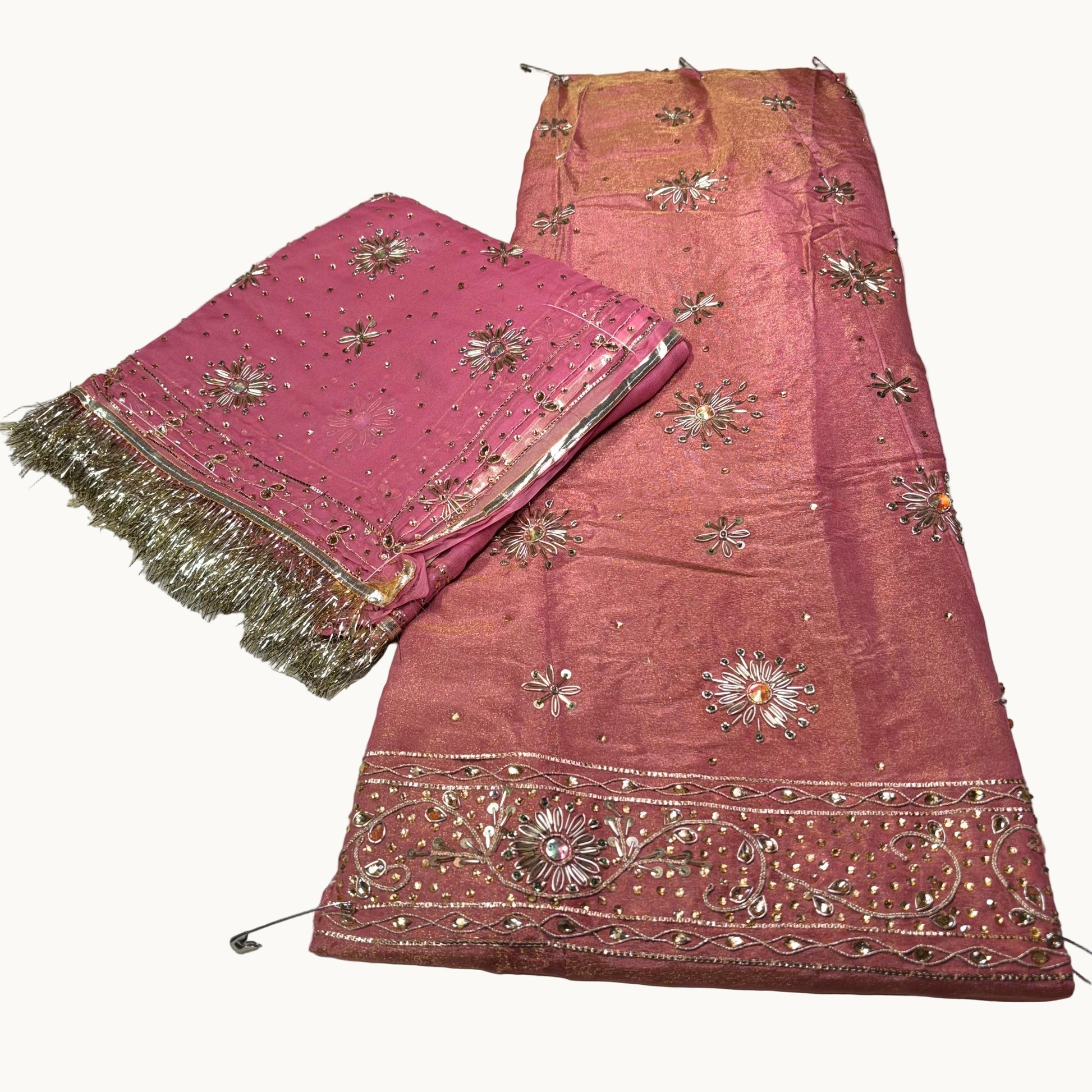 Pink fabric with gold embroidery on a white background