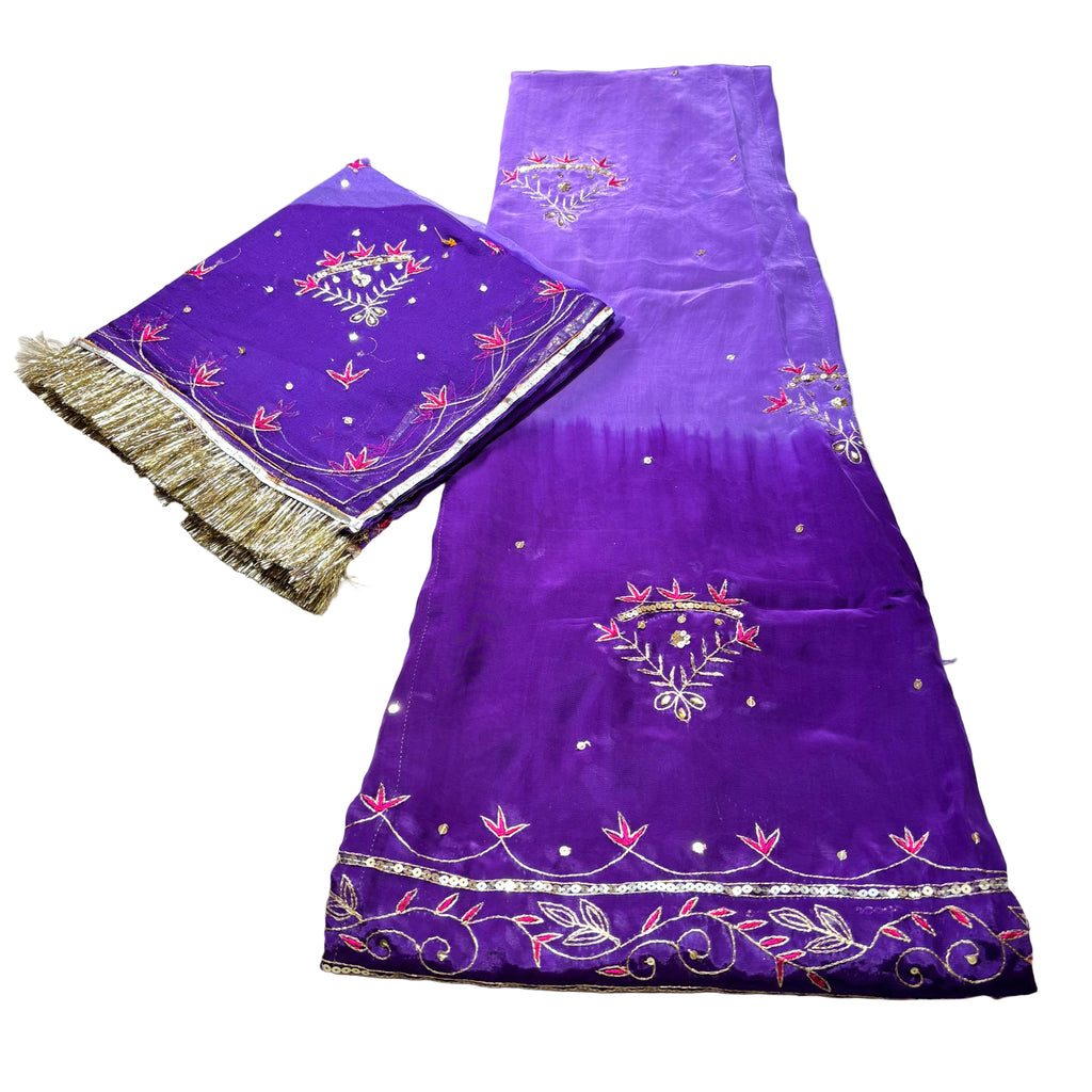 Purple fabric with embroidery on a light gray surface