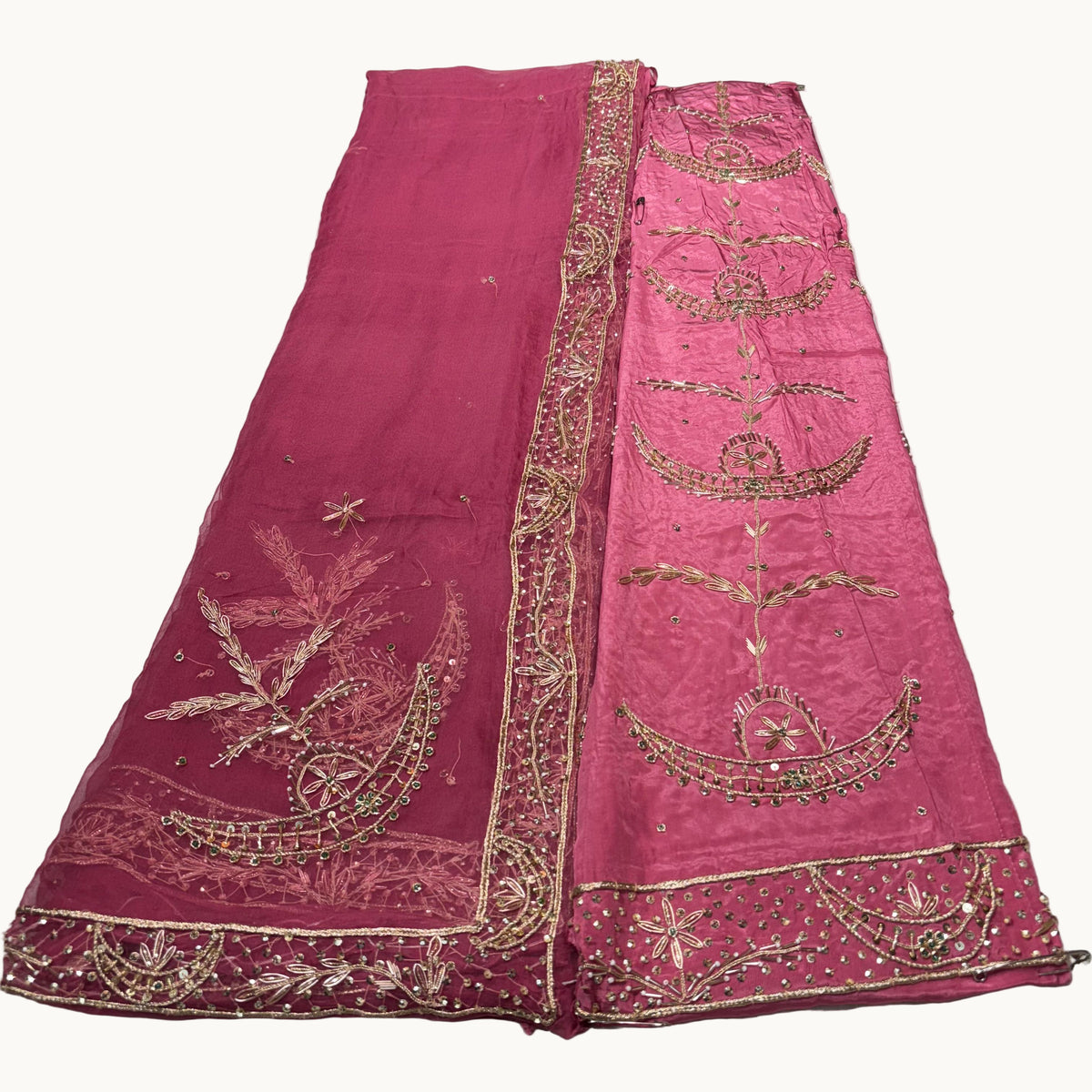 Pink embroidered fabric on a light gray background