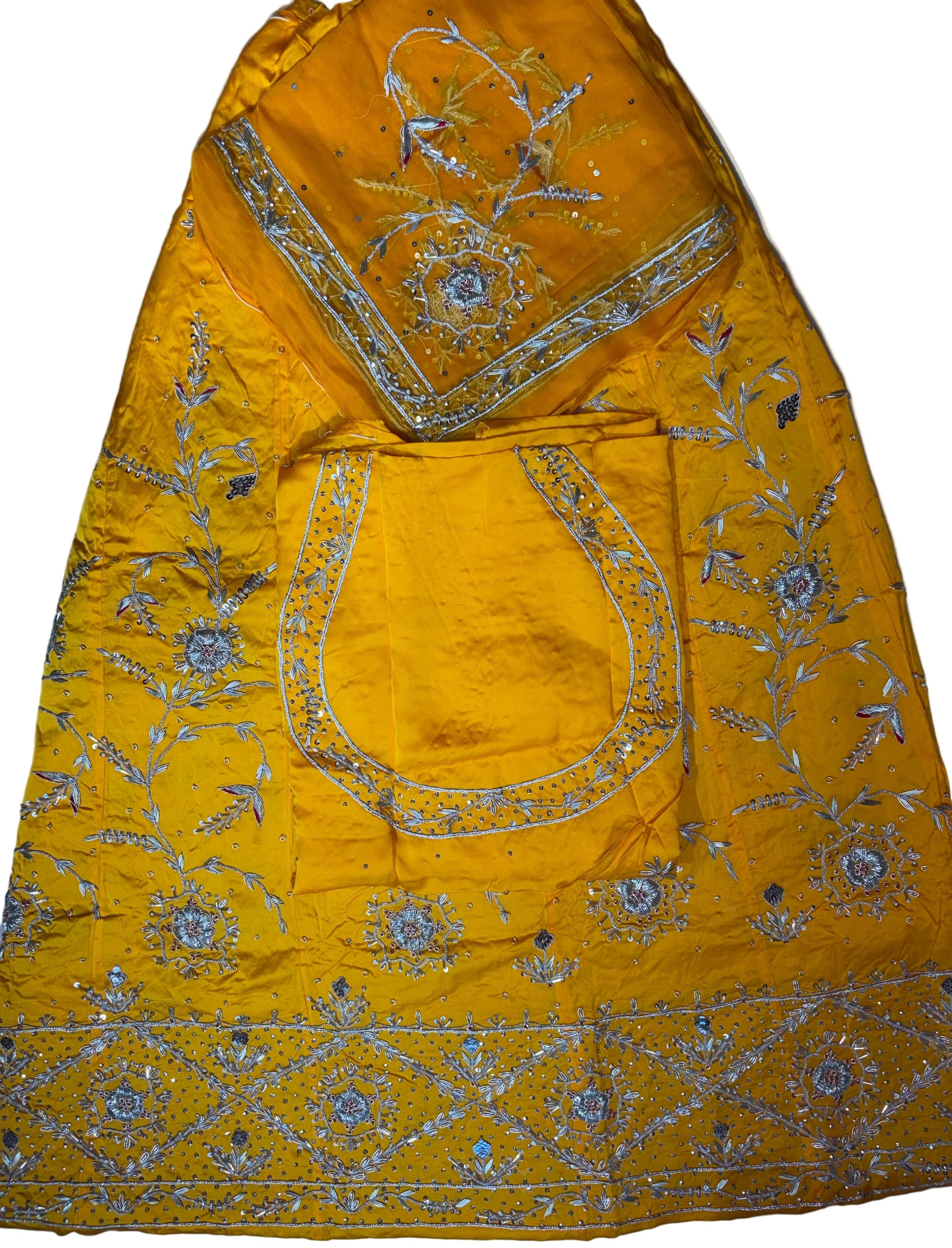 Yellow embroidered fabric with intricate patterns on a plain background