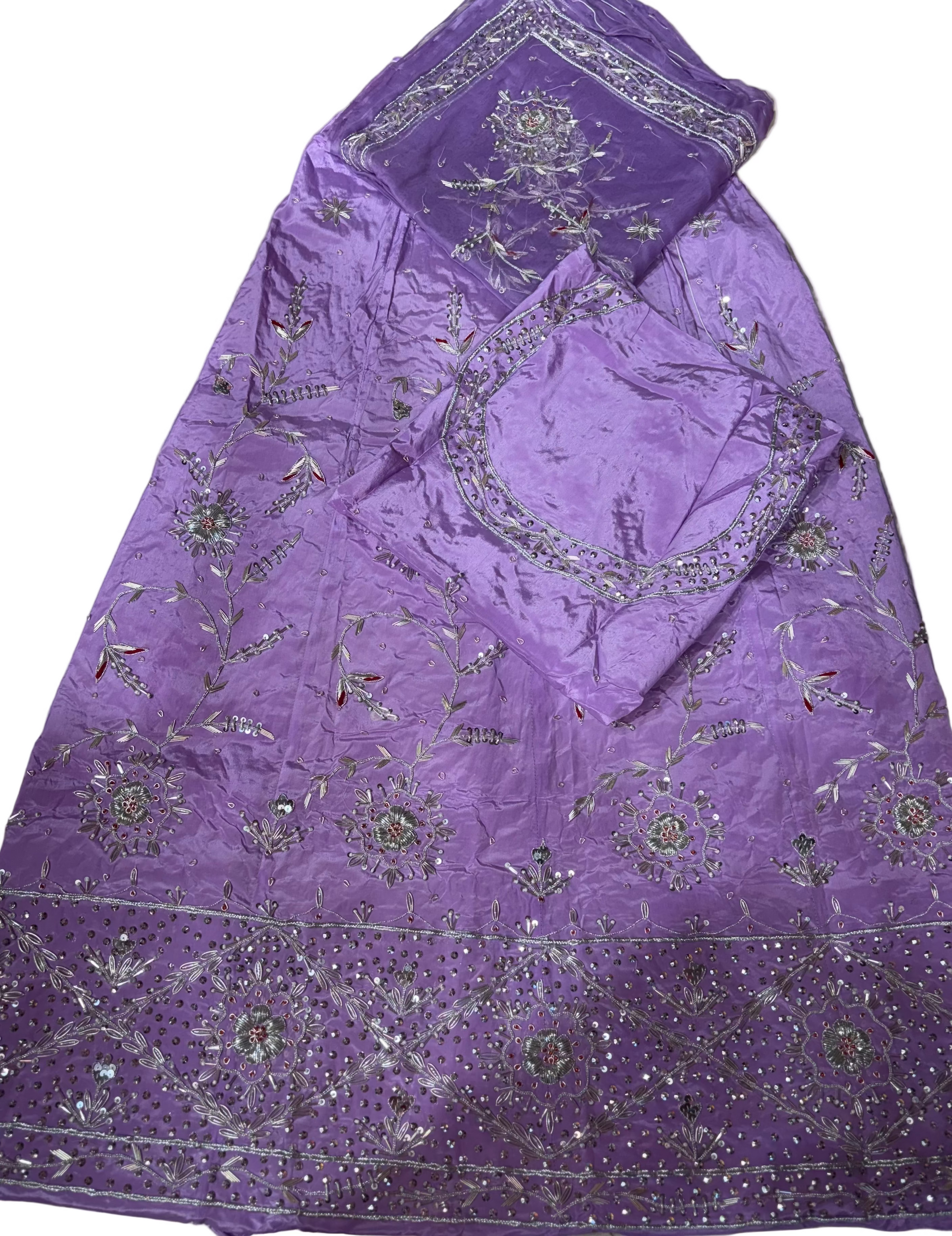 Purple fabric with silver embroidery on a light-colored surface