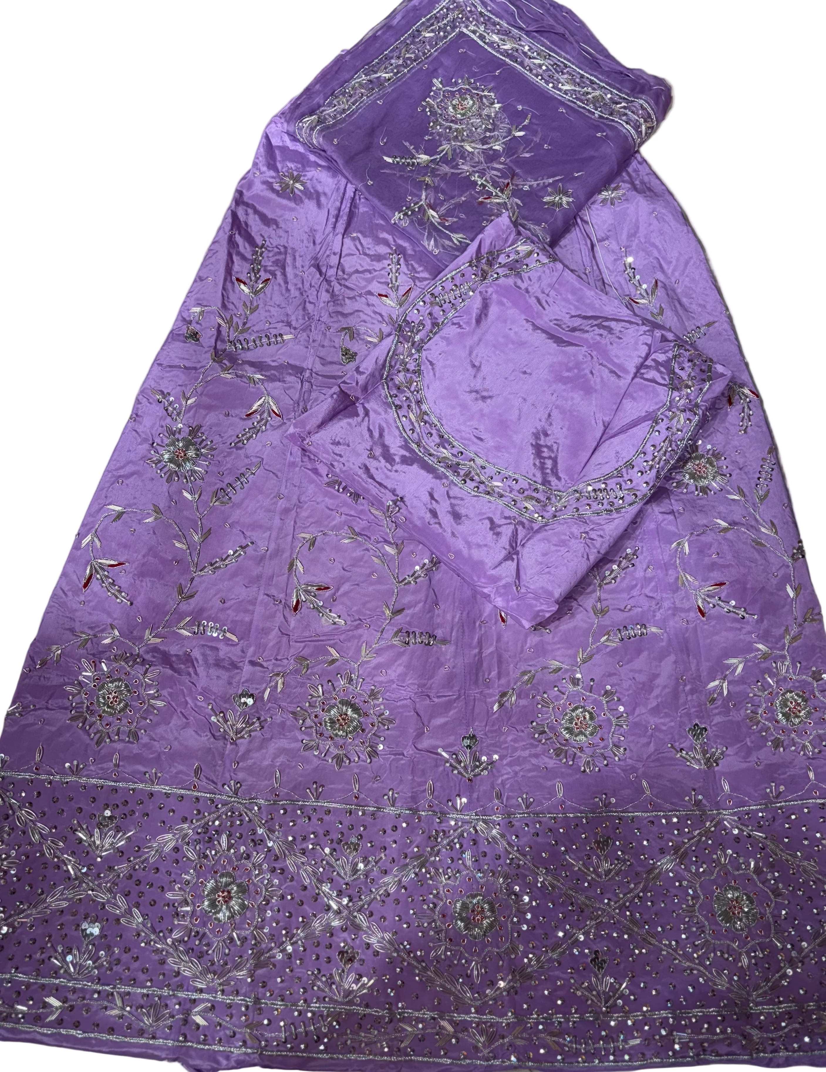 Purple fabric with silver embroidery on a light-colored surface