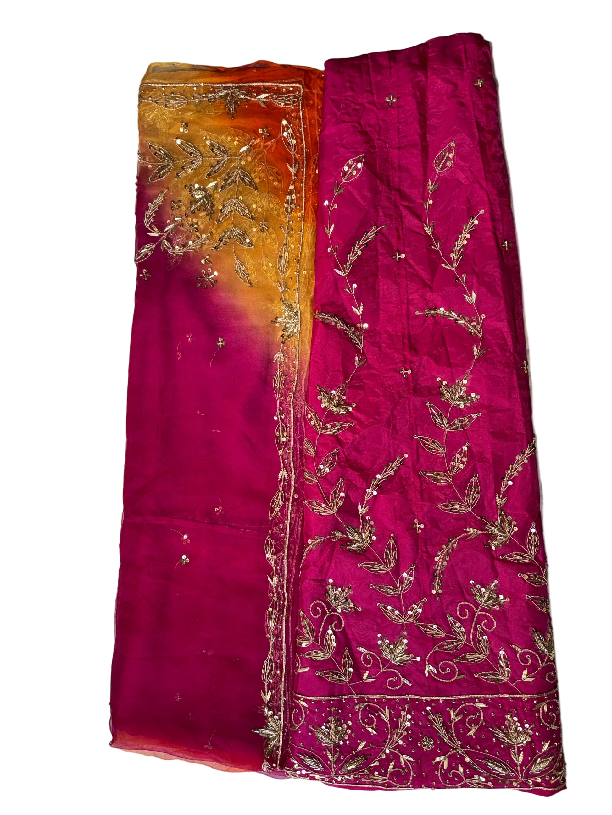Two embroidered fabric pieces on a textured surface