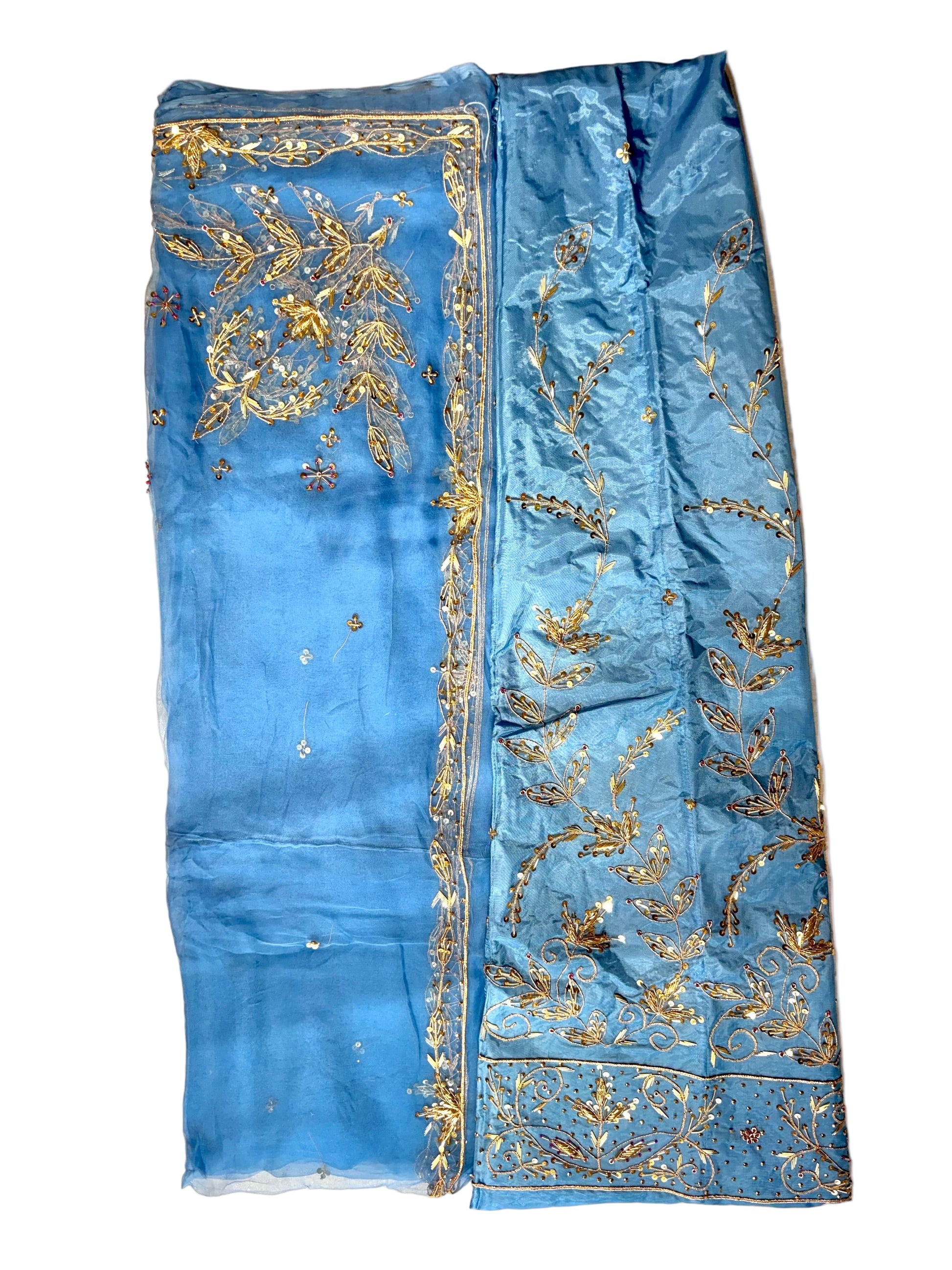 Blue fabric with gold embroidery on a beige background
