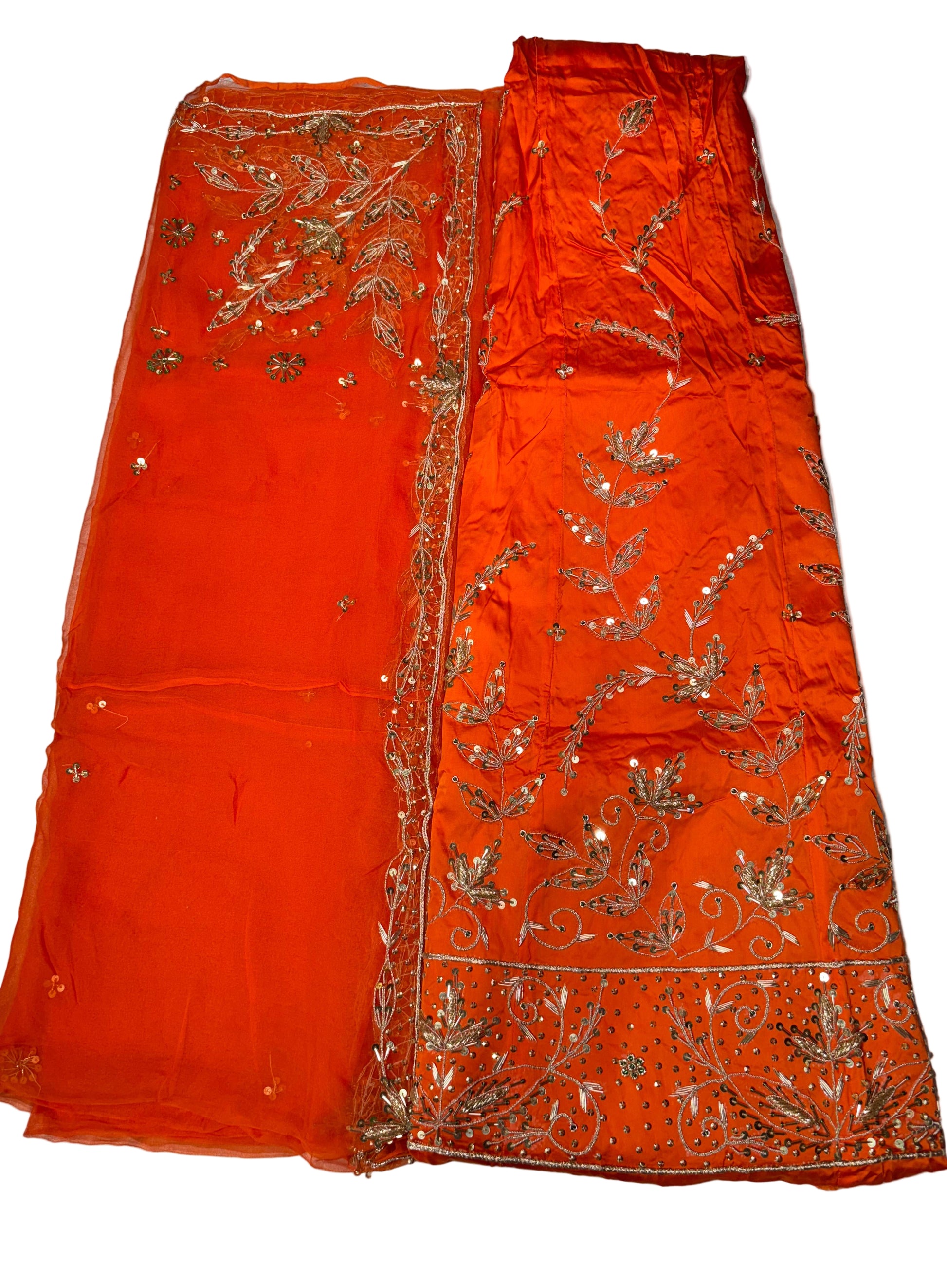 Orange fabric with gold embroidery on a white background