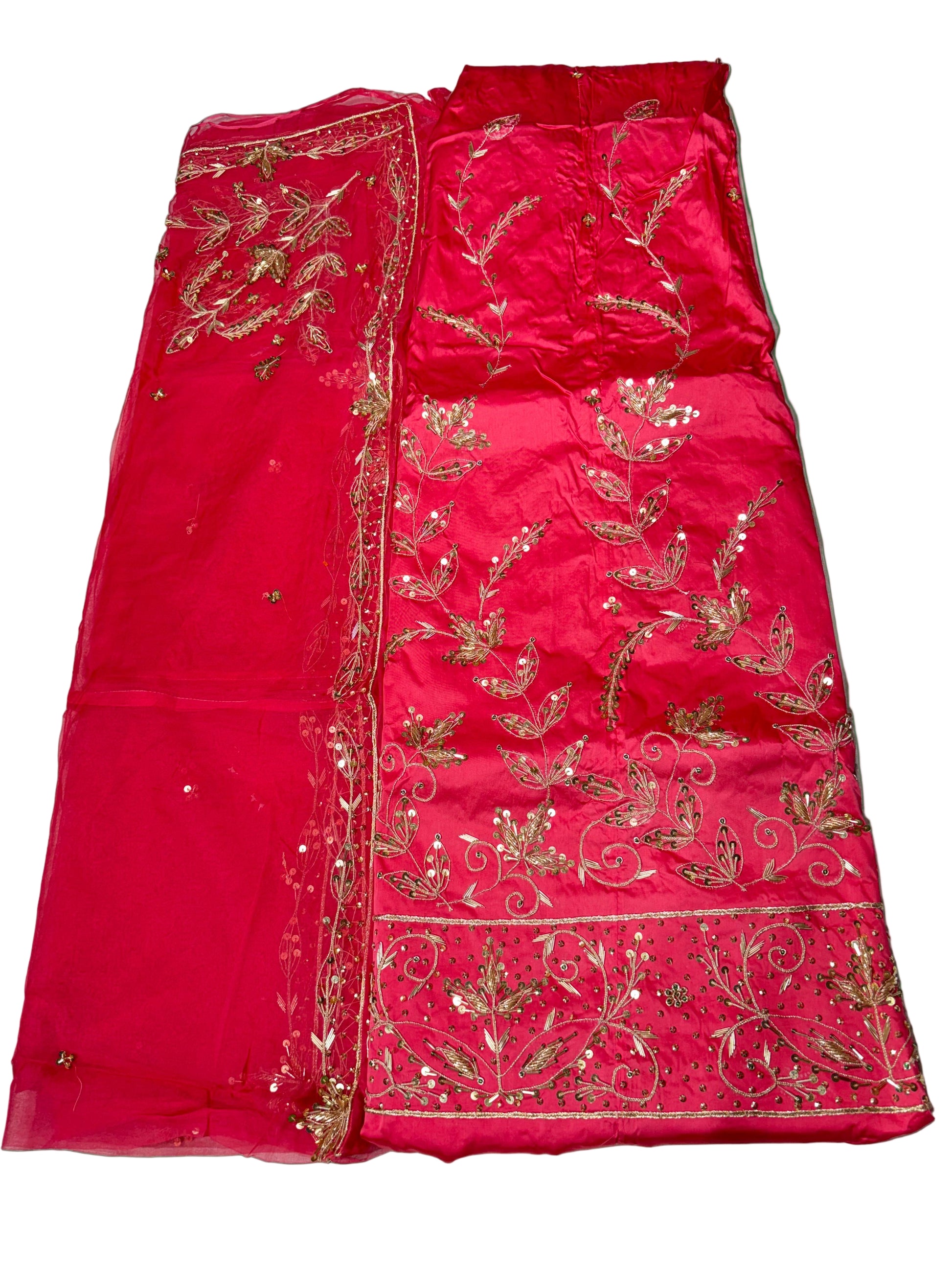 Red fabric with gold embroidery on a white surface