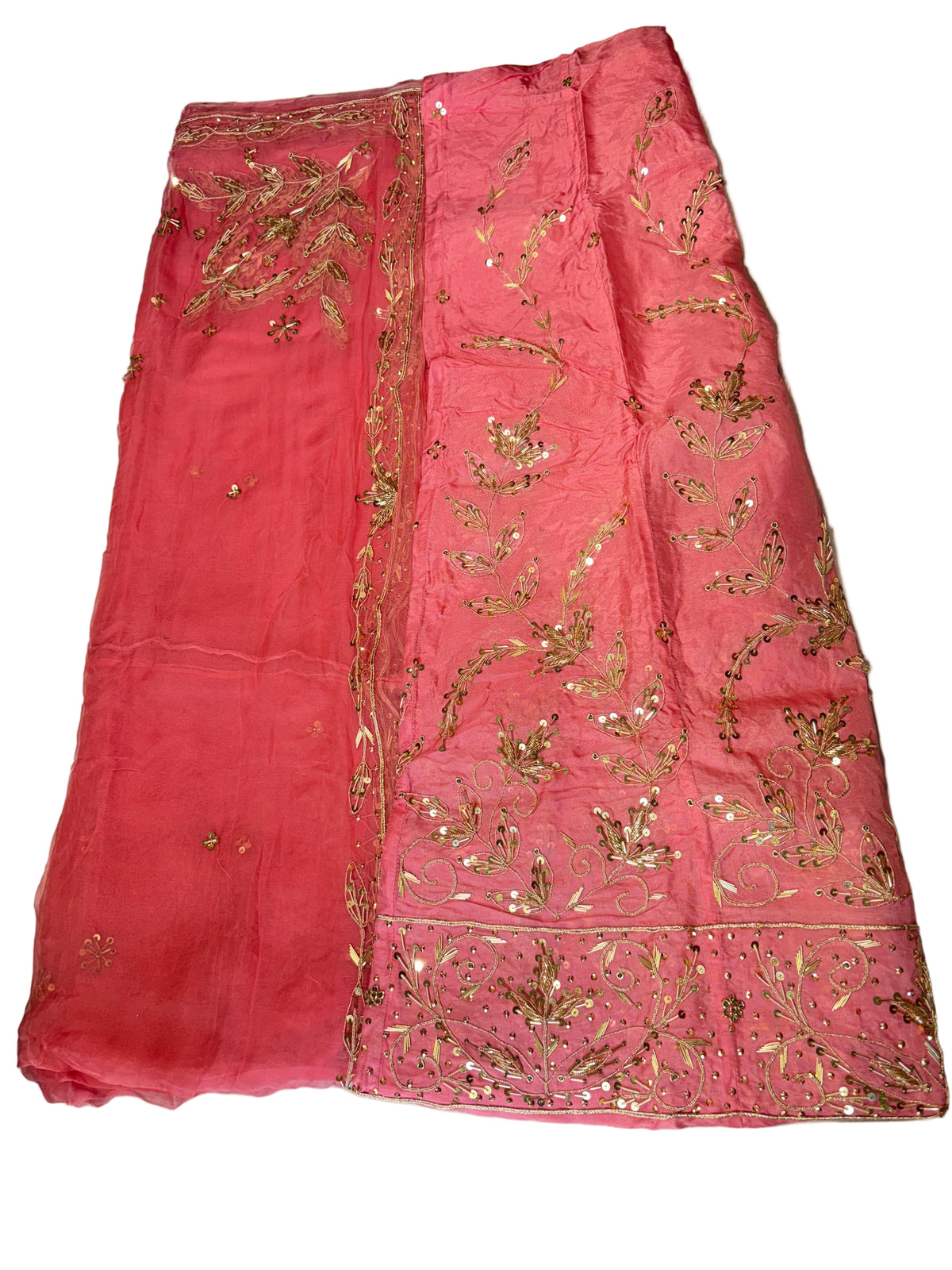 Pink embroidered fabric on a light-colored surface