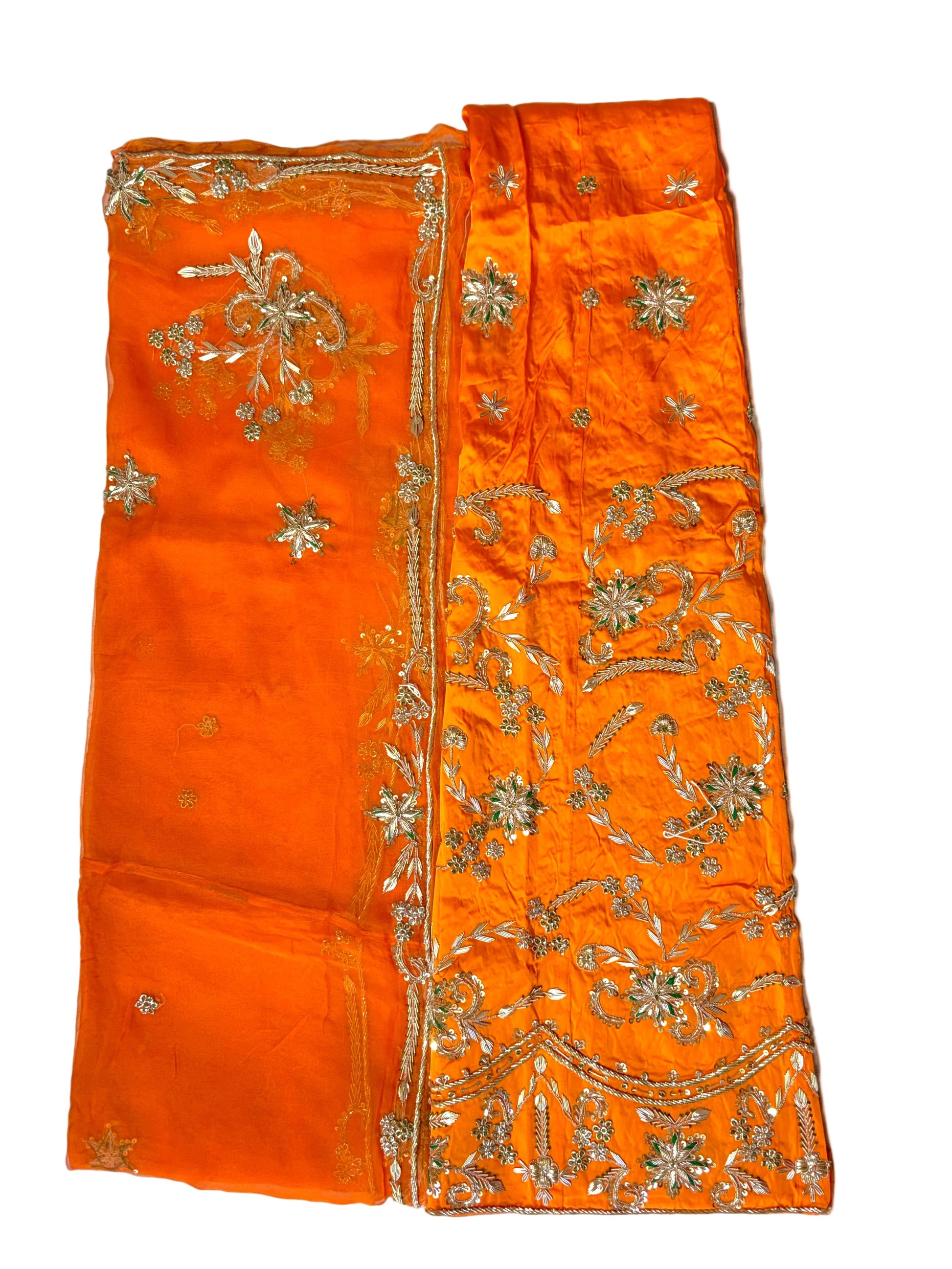 Orange fabric with intricate gold embroidery on a white background