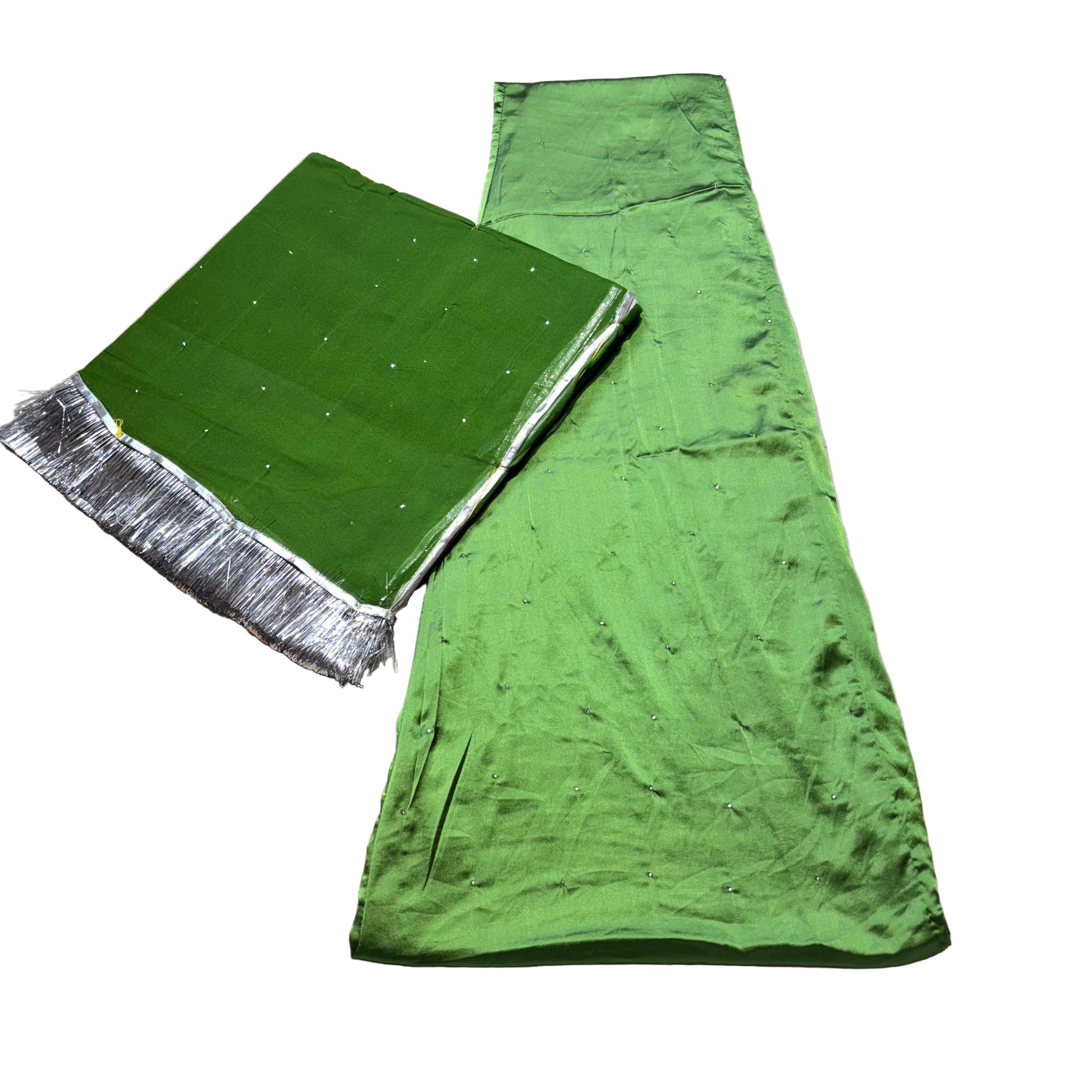 Green fabric with silver border on a beige surface