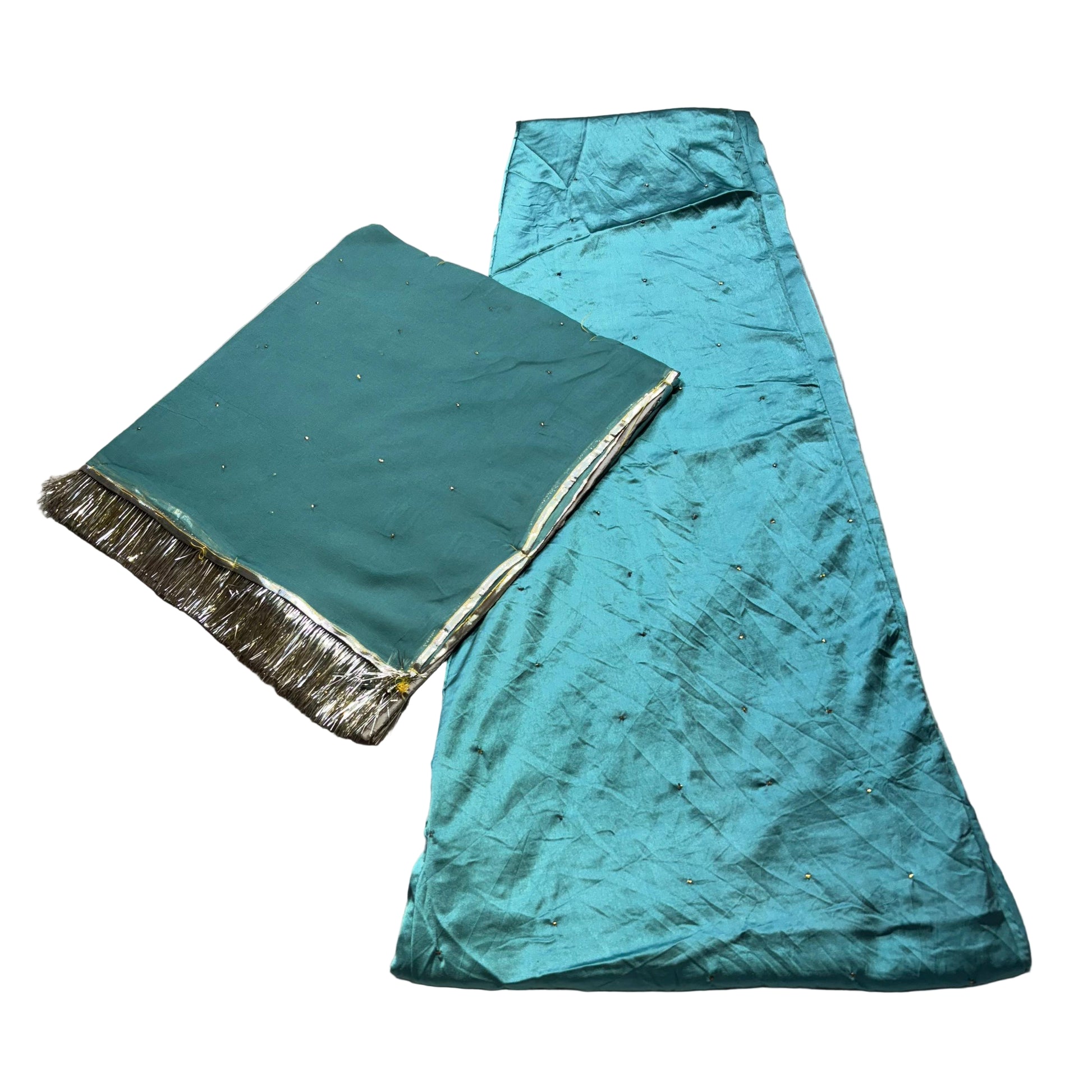 Two pieces of teal fabric with gold trim on a textured surface