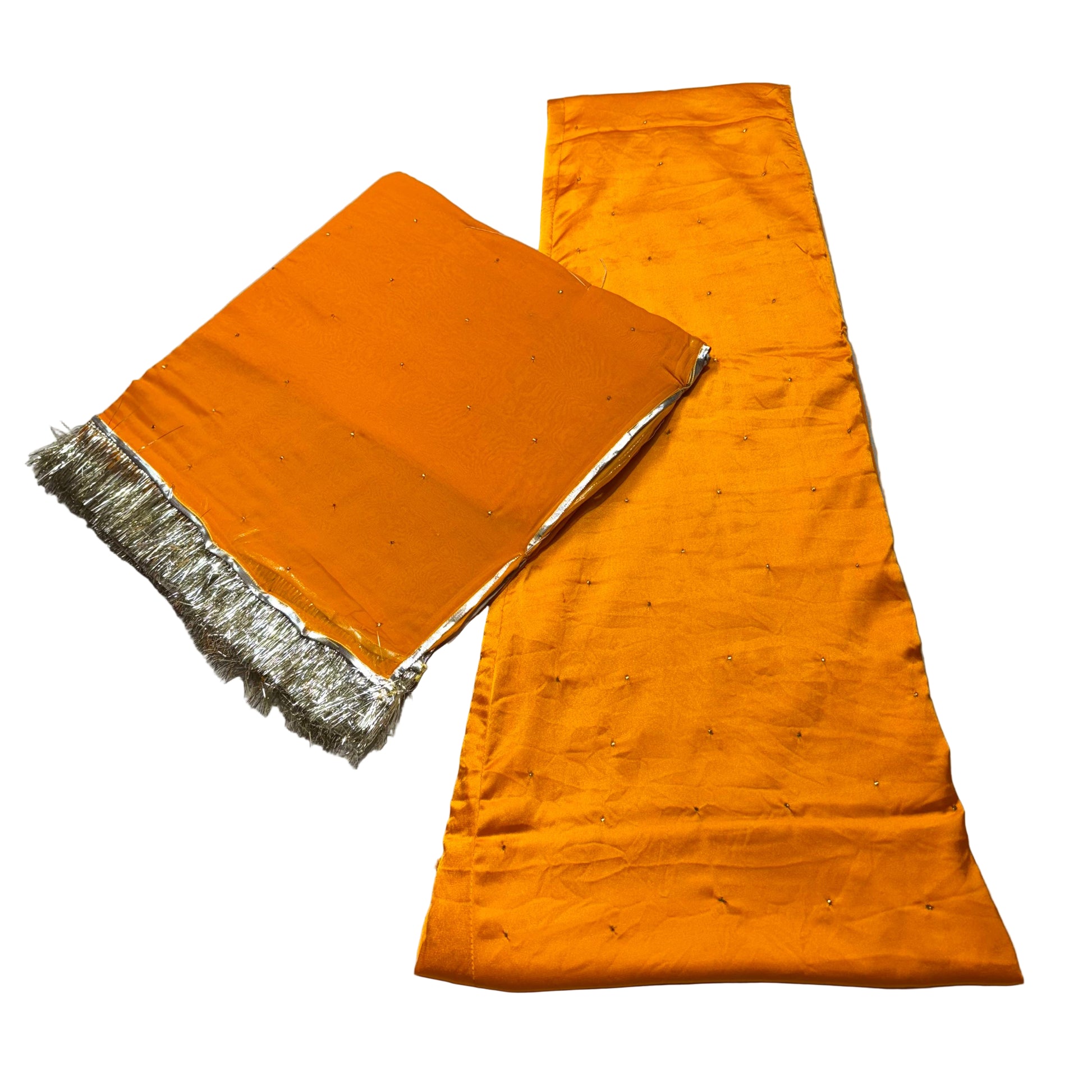 Orange fabric with silver border on a gray surface